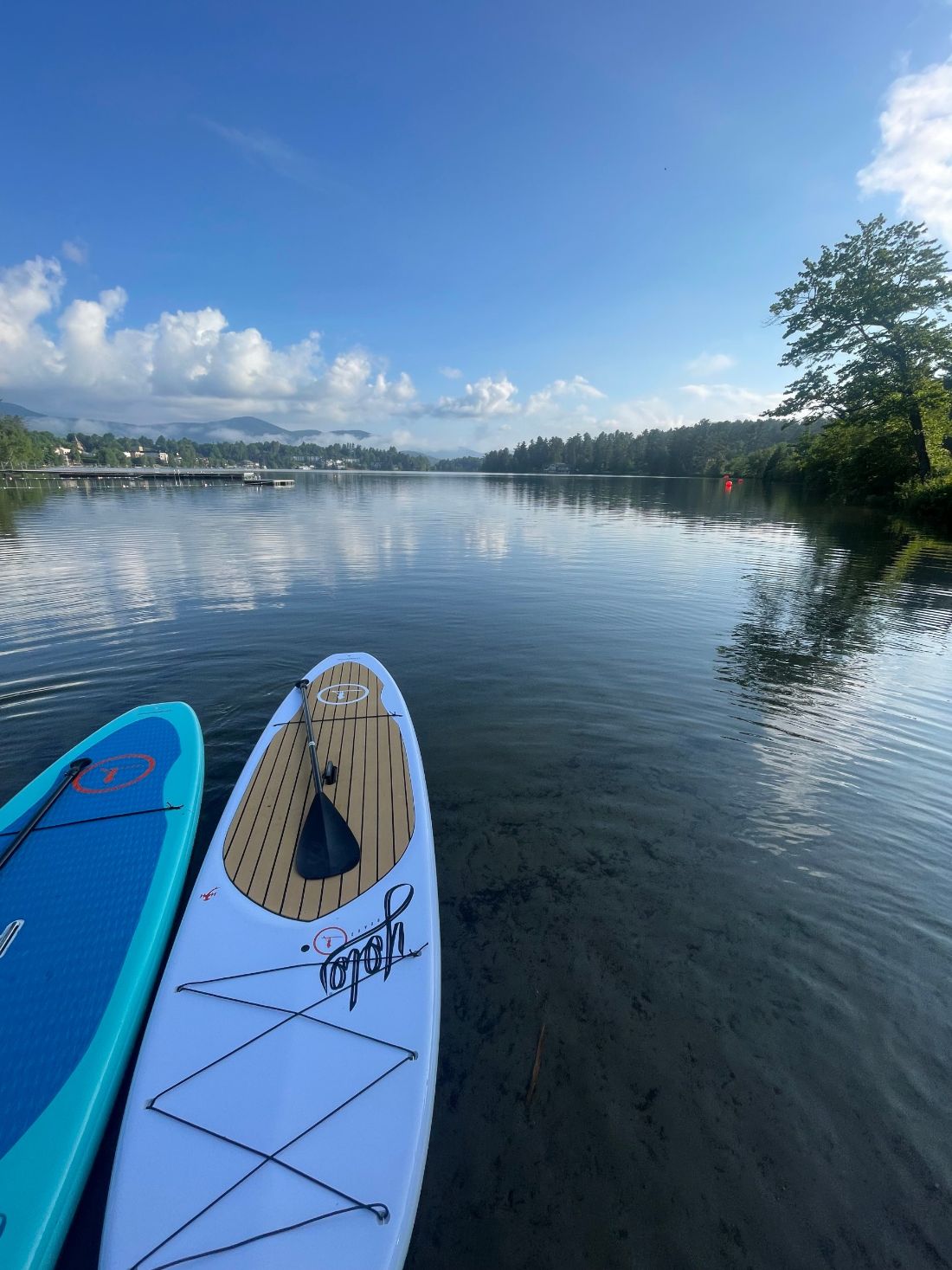 Two paddleboards waiting at the shore of Mirror Lake