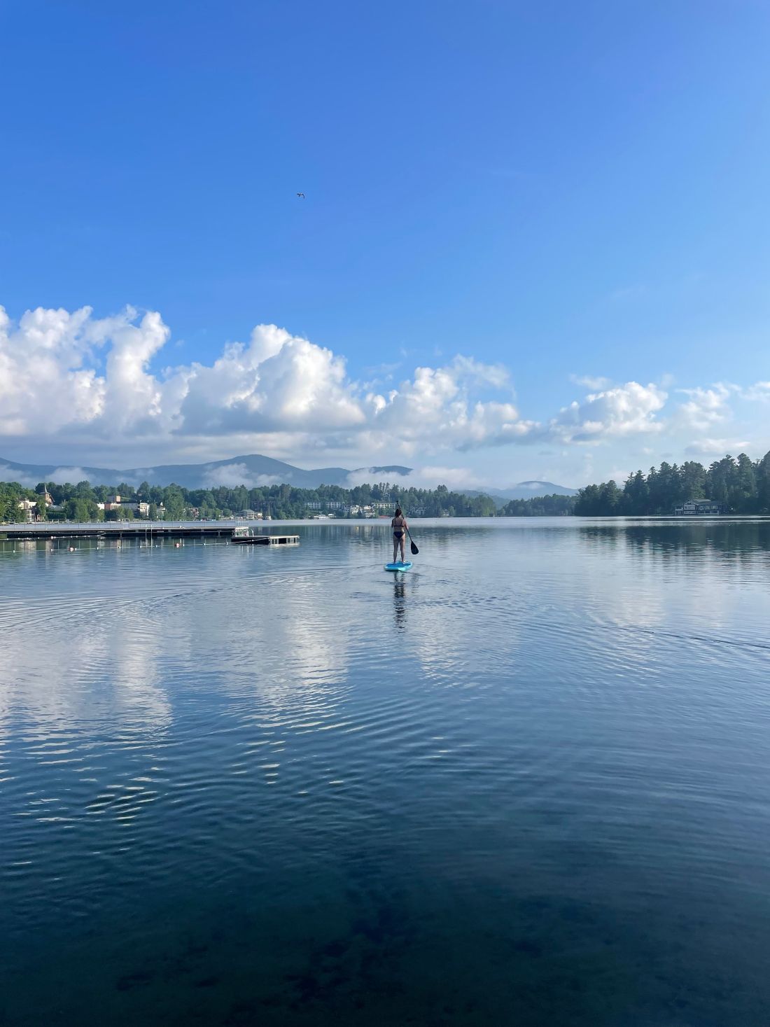 Paddler heading out on calm Mirror Lake
